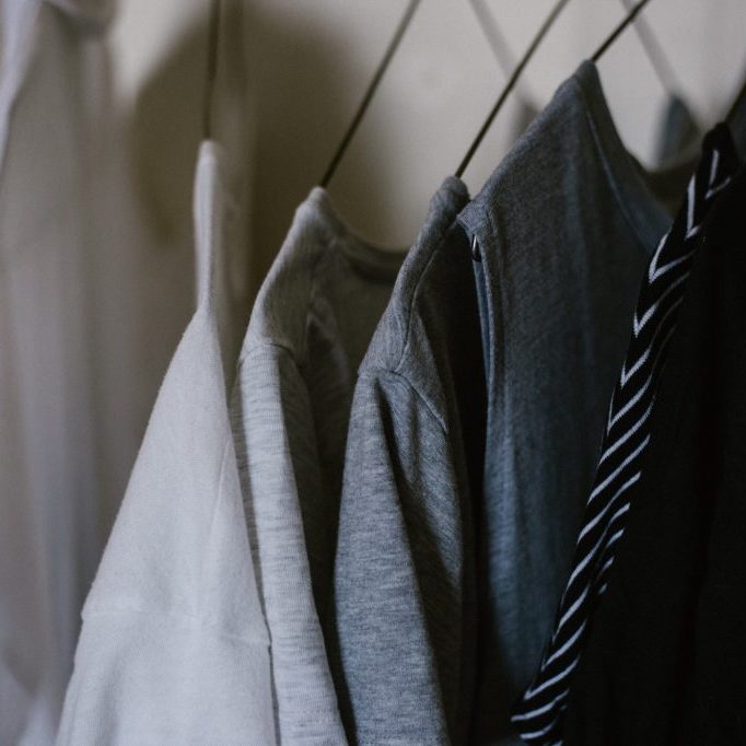 grey and white clothes in hangers